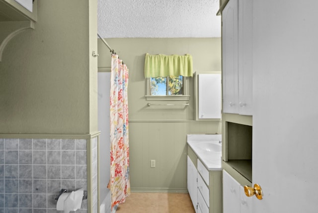 bathroom with vanity, tile patterned floors, a textured ceiling, and a shower with shower curtain