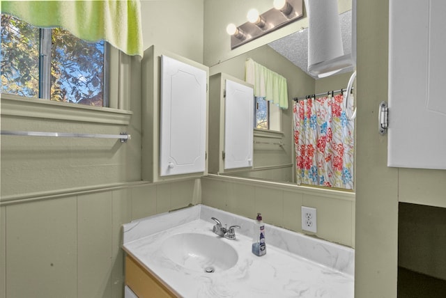 bathroom featuring vanity and a shower with shower curtain