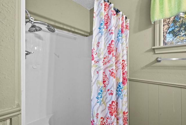 bathroom featuring walk in shower and a textured ceiling