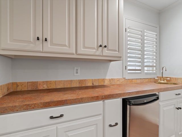 kitchen featuring ornamental molding, white cabinetry, and sink