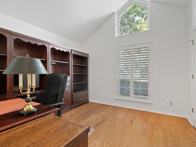 home office featuring high vaulted ceiling and light wood-type flooring