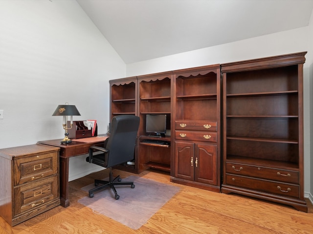 home office with light hardwood / wood-style flooring and vaulted ceiling