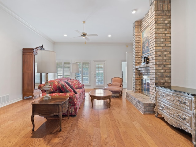 living room with crown molding, light wood-type flooring, and ceiling fan