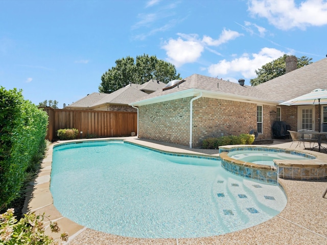 view of pool featuring an in ground hot tub and a patio area