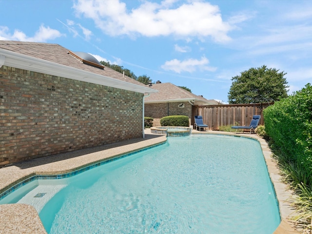 view of pool featuring an in ground hot tub