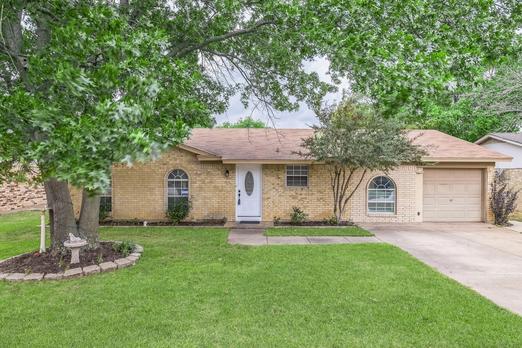 ranch-style home with a front yard and a garage