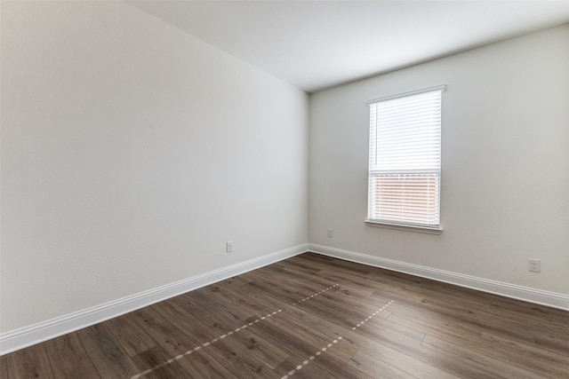 spare room featuring dark hardwood / wood-style flooring