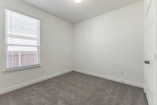empty room with dark colored carpet