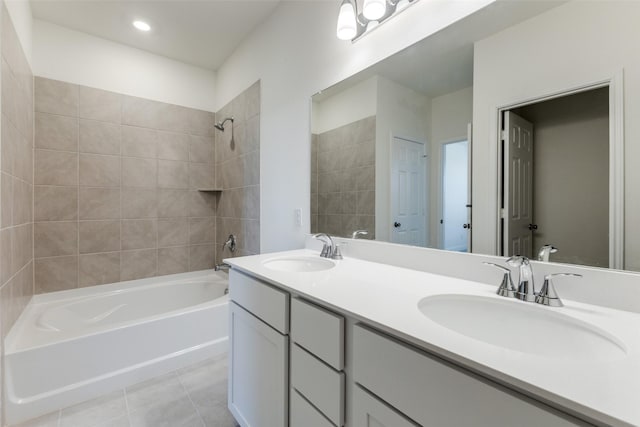 bathroom with tiled shower / bath, vanity, and tile patterned flooring
