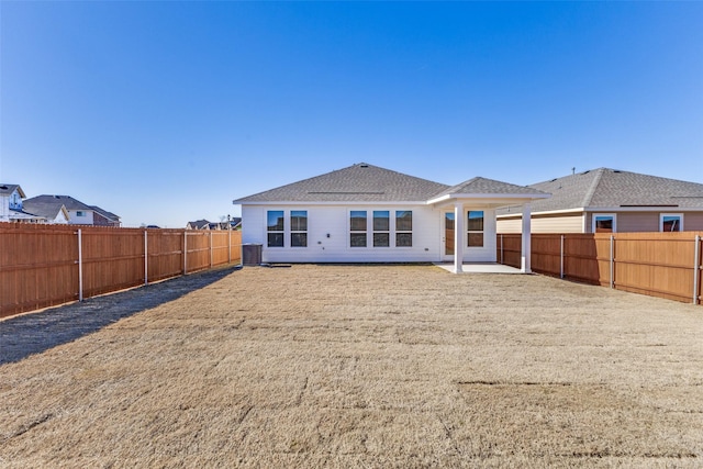 back of property featuring a lawn, a patio, and central air condition unit