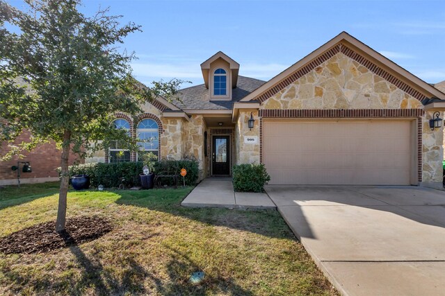 view of front of home with a garage and a front yard