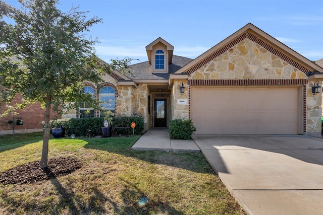 view of front of property with driveway, stone siding, a garage, and a front yard