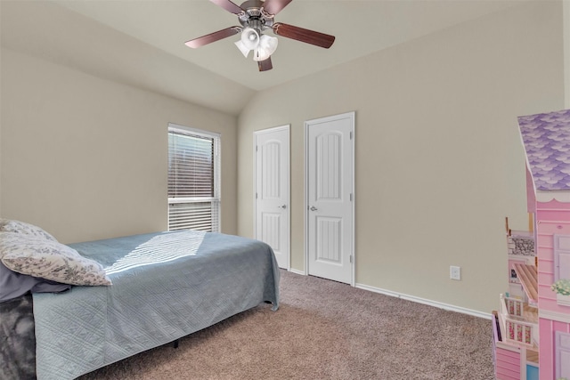 carpeted bedroom with ceiling fan and vaulted ceiling