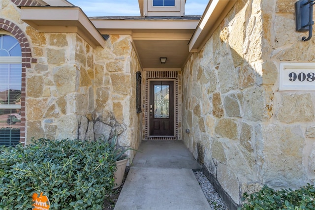 doorway to property with stone siding