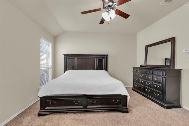 carpeted bedroom with ceiling fan and vaulted ceiling