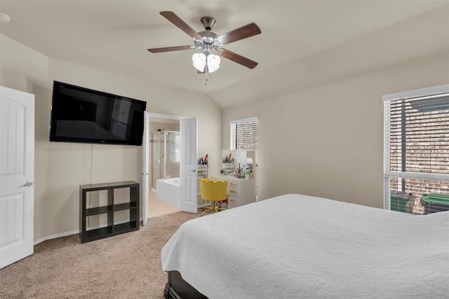 carpeted bedroom with ceiling fan, vaulted ceiling, and connected bathroom