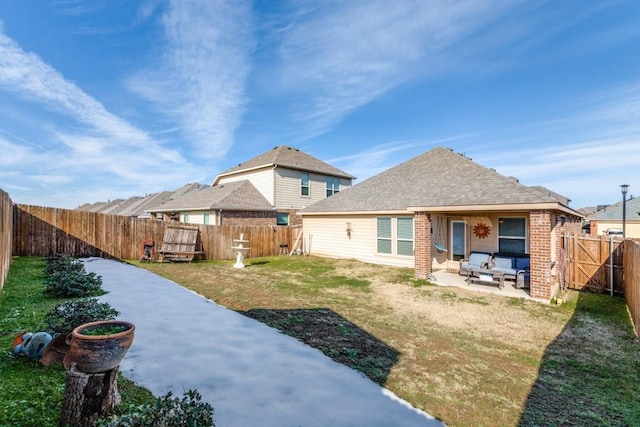 rear view of house with a patio area and a yard