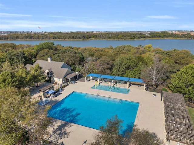 view of swimming pool featuring a water view and a patio