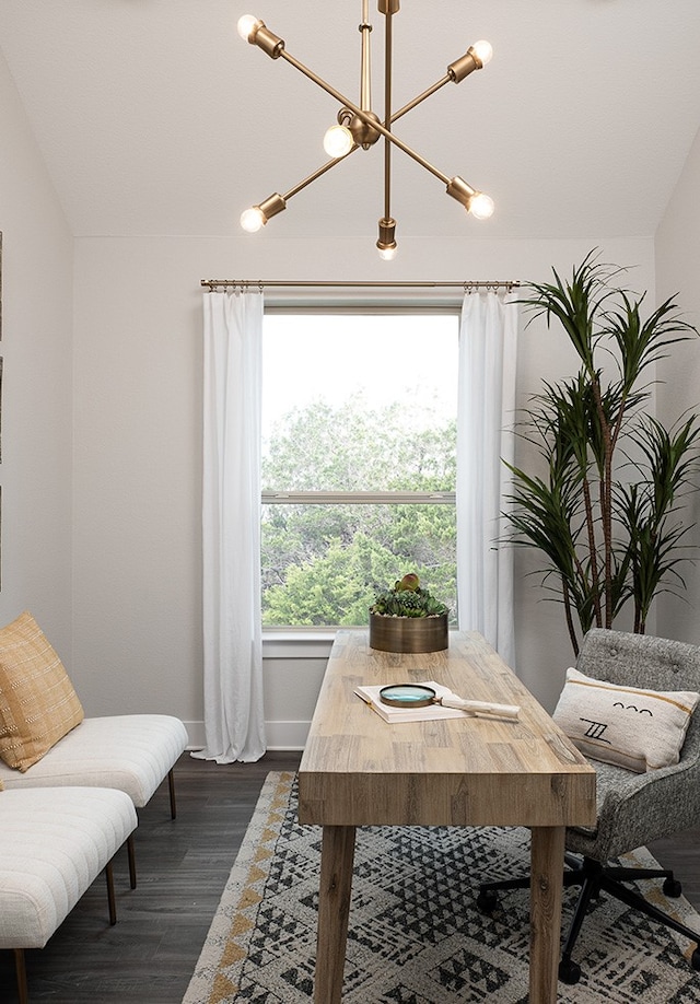 dining area with dark wood-style flooring, an inviting chandelier, and baseboards