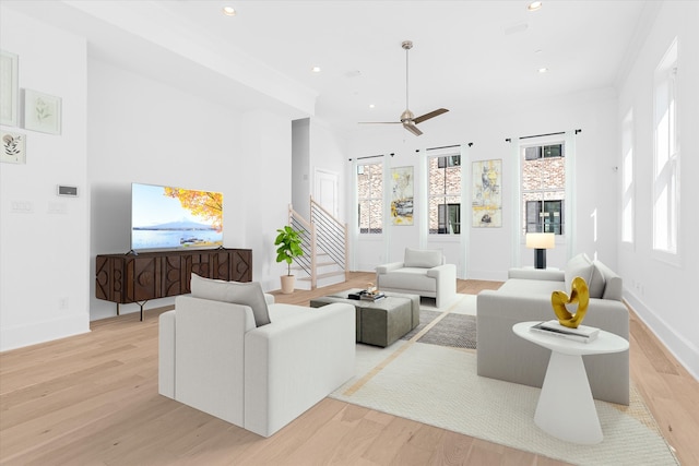 living room with ceiling fan and light wood-type flooring