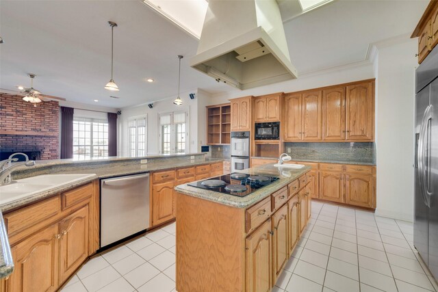 kitchen featuring black appliances, sink, hanging light fixtures, a kitchen island, and island exhaust hood