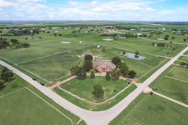 birds eye view of property featuring a rural view and a water view