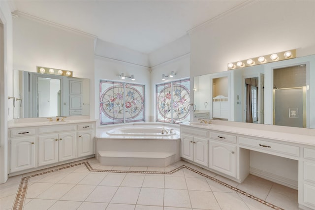 bathroom featuring tile patterned floors, vanity, and shower with separate bathtub