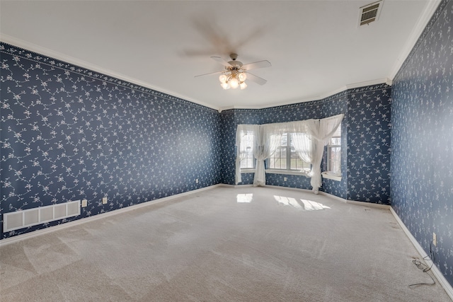 empty room featuring carpet flooring, ceiling fan, and ornamental molding