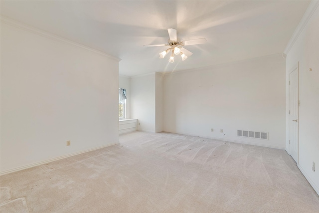 carpeted spare room with crown molding and ceiling fan