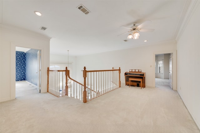 hallway featuring light colored carpet and crown molding