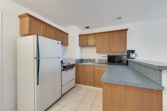 kitchen with sink, light tile patterned floors, and white appliances