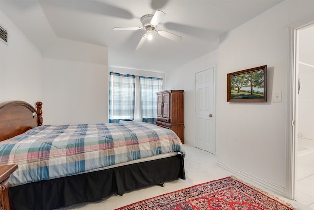 carpeted bedroom featuring ceiling fan and ensuite bath