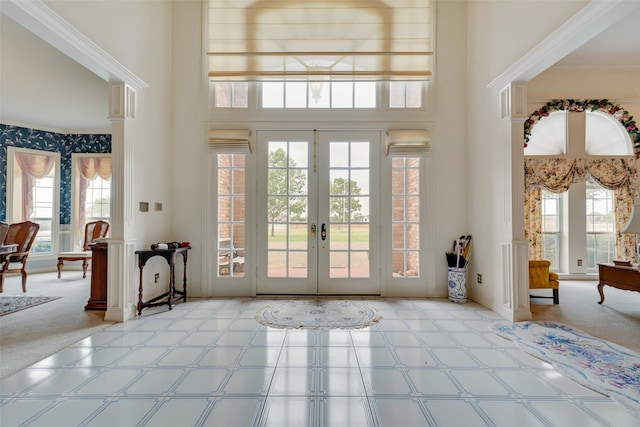 doorway featuring light carpet, french doors, and a towering ceiling