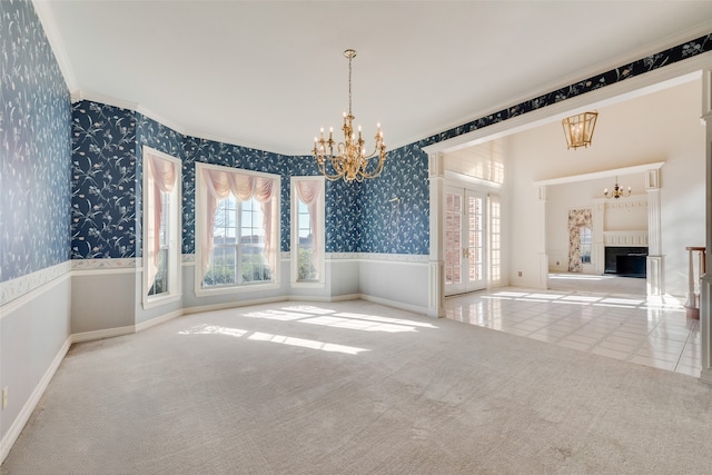 interior space featuring light carpet, ornamental molding, and an inviting chandelier