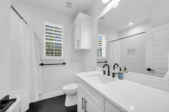 full bathroom featuring tile patterned flooring, vanity, toilet, and a wealth of natural light