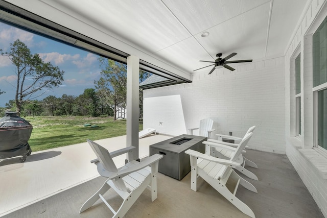 view of patio / terrace with a fire pit and a storage shed