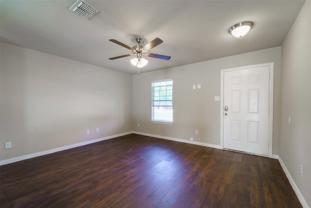 empty room featuring ceiling fan and dark hardwood / wood-style flooring