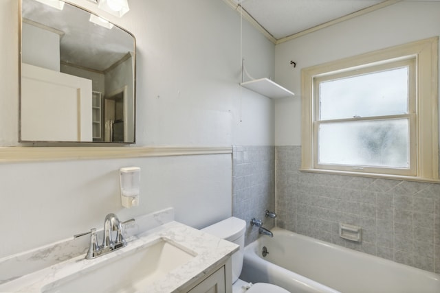 full bathroom with toilet, ornamental molding, vanity, and tub / shower combination