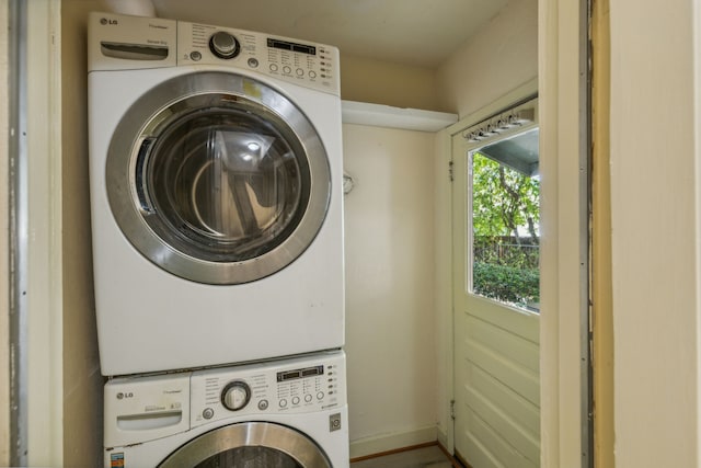 washroom featuring stacked washer / drying machine