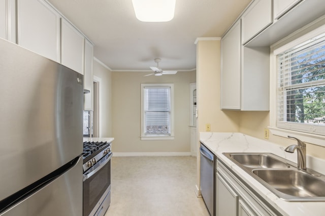 kitchen featuring sink, ceiling fan, stainless steel appliances, white cabinets, and crown molding