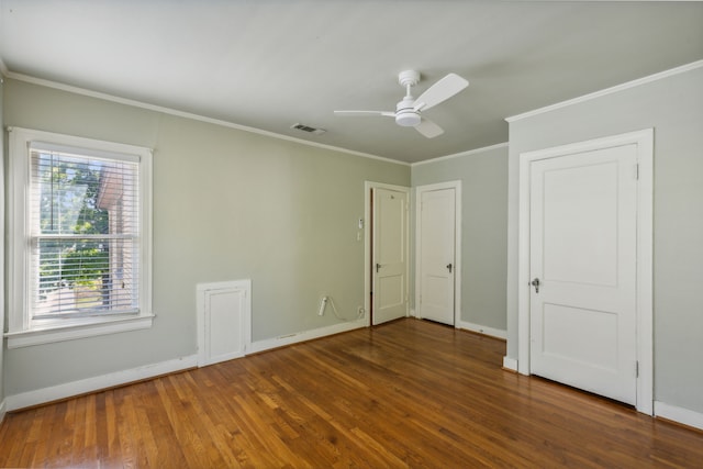 unfurnished bedroom with ornamental molding, ceiling fan, and dark hardwood / wood-style flooring