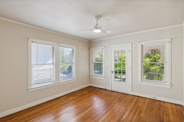 unfurnished room featuring hardwood / wood-style floors, crown molding, and ceiling fan