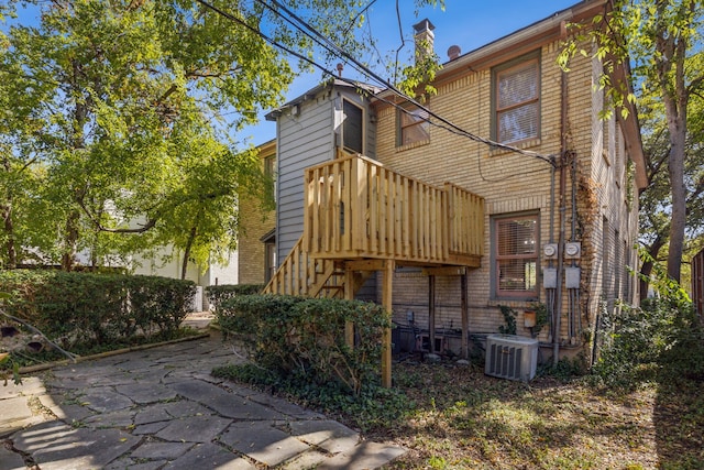 rear view of house with a patio and central AC