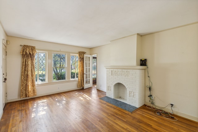 unfurnished living room with a fireplace and hardwood / wood-style flooring