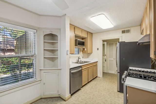 kitchen featuring appliances with stainless steel finishes, light carpet, a textured ceiling, and range hood