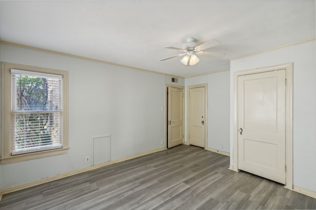 unfurnished bedroom featuring ceiling fan, ornamental molding, and hardwood / wood-style floors