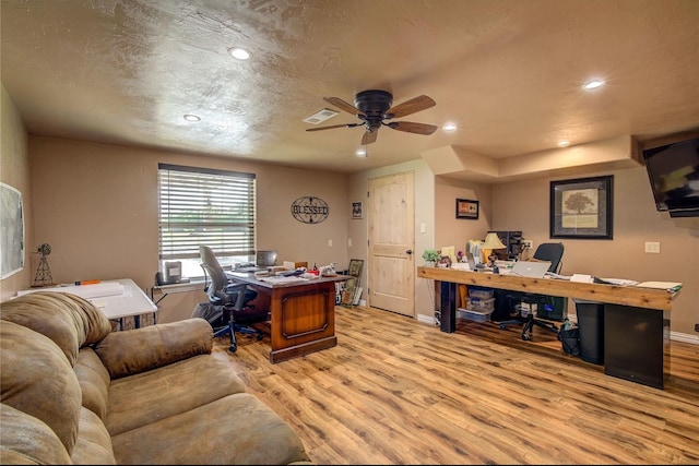 office area featuring light hardwood / wood-style flooring, a textured ceiling, and ceiling fan