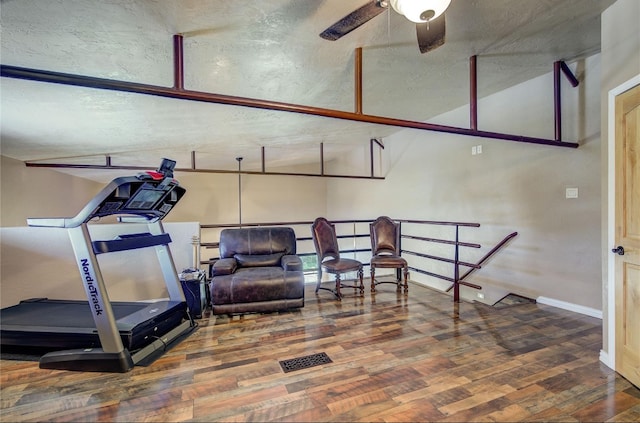 workout area with a textured ceiling, hardwood / wood-style flooring, and ceiling fan