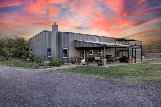 exterior space with a patio area and a lawn