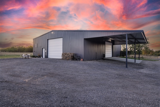 outdoor structure at dusk featuring a garage